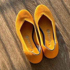 Rothy’s the flat marigold yellow/orange solid color